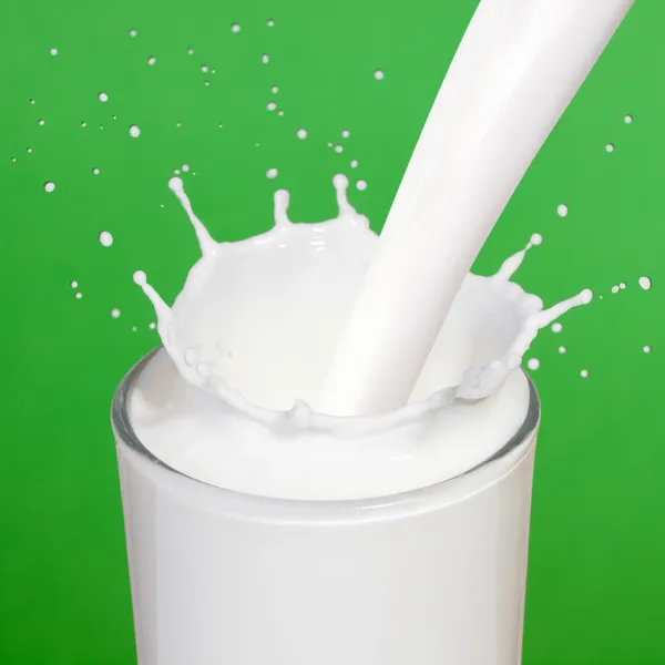Milk pouring into a glass. — Stock Photo, Image