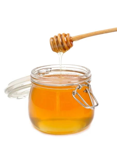 stock image Jar of honey with wooden drizzler