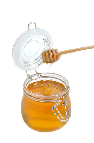 Open jar of honey and drizzler on a white background — Stock Photo, Image