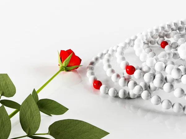 Composition with a rose and the necklaces — Stock Photo, Image