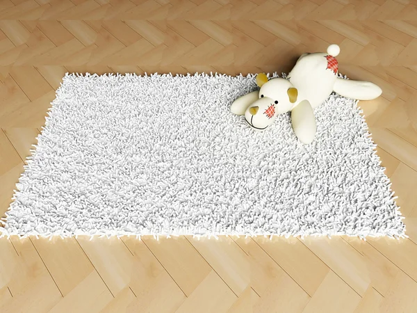 Мягкая игрушка на ковре — стоковое фото