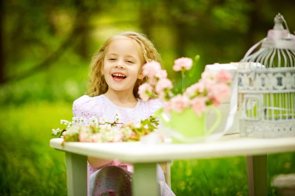 Little blonde playing in the spring garden — Stock Photo, Image