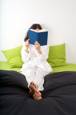 Reading on green bed