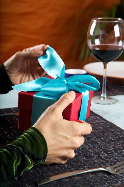 Opening a blue bow gift — Stock Photo, Image