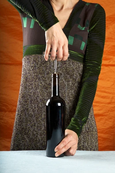 Žena otevření víno láhev — Stock fotografie
