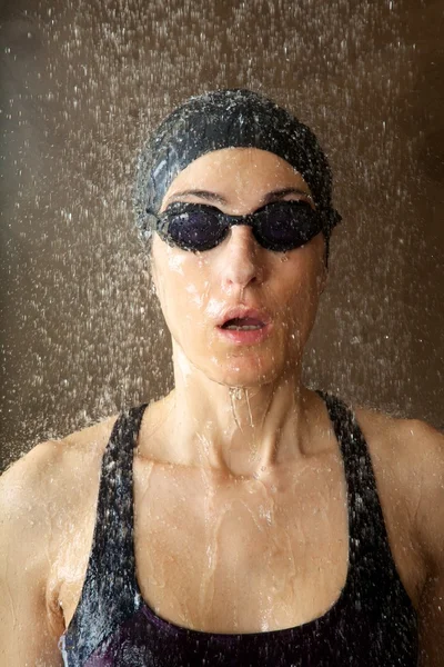 Woman with goggles under water drops — Stock Photo, Image