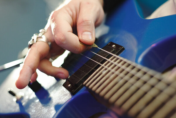 Rockstar playing solo on guitar.