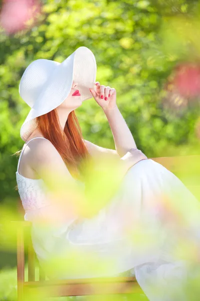 Mysterious girl in a garden — Stock Photo, Image