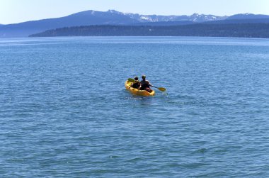 Yellow canoe on Lake Tahoe, CA. clipart