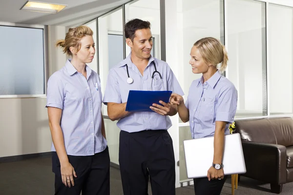 Young doctor with two nurses — Stock Photo, Image