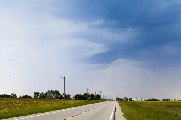 Country Road with stormy sky — Stock Photo, Image