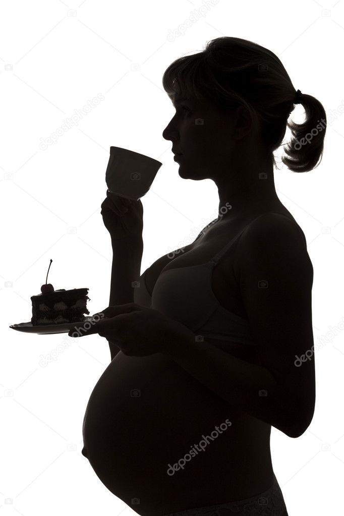 Silhouette of the pregnant woman with a cup of tea