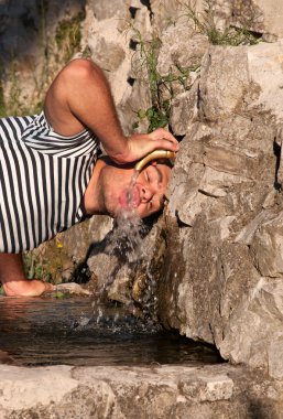 Young man drinking water clipart