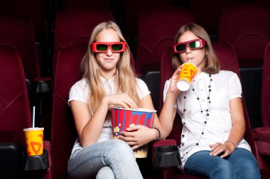 Two girls look three-dimensional cinema clipart