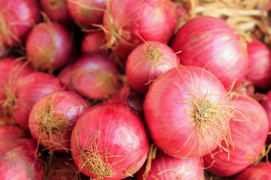 Fresh ripe heap of pink colored salad onions clipart