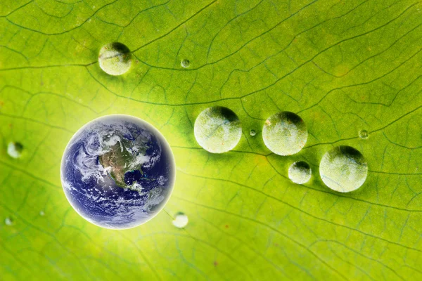 Nature conservation- glowing earth & water drops — Stock Photo, Image