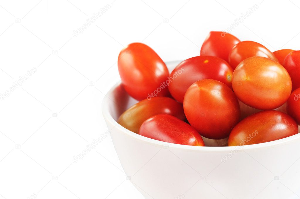 Group of fully ripe organic cherry tomatoes in bright red color