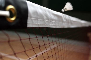 Photo of shuttle badminton net up close and a fast moving shuttl clipart