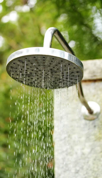 stock image Metal water shower in the open outdoors at a hotel spa with fres