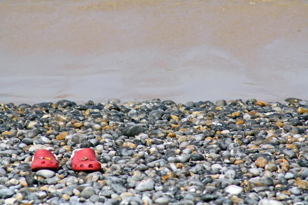 Sandálias em uma praia — Fotografia de Stock