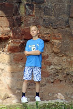 Teenage boy stood near castle clipart