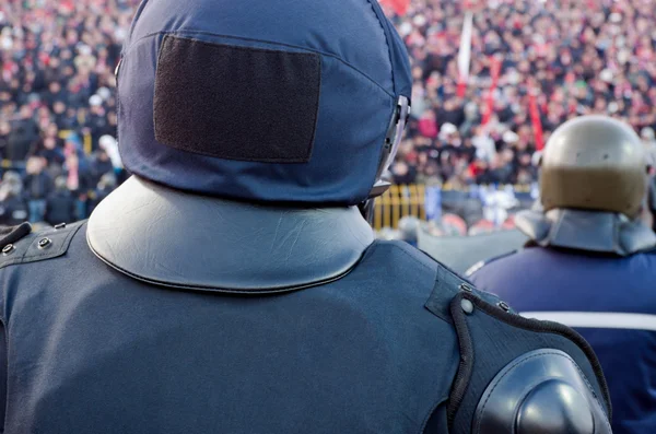 Back of policeman guarding fans — Stock Photo, Image