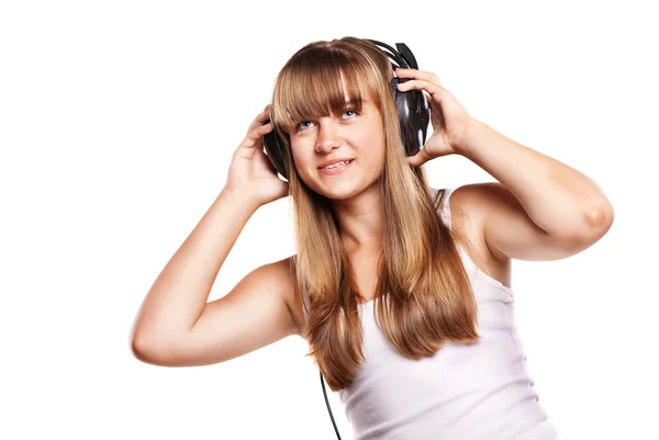 Chica encantadora escuchando una música en auriculares —  Fotos de Stock