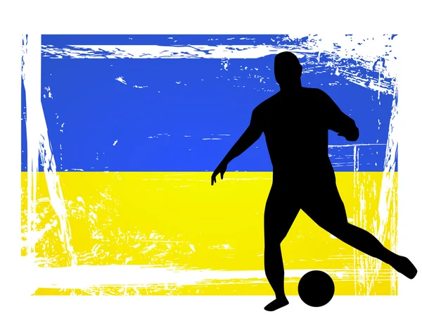Футболист перед украинским флагом — стоковое фото