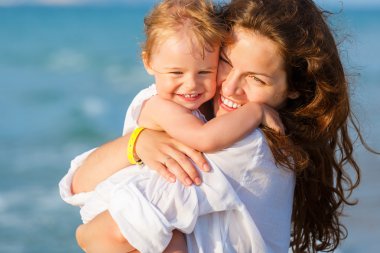 Mother and daughter on the beach clipart