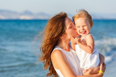 Mother and daughter on the beach clipart