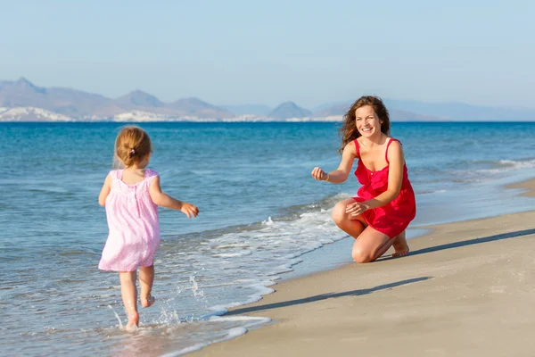 Moeder met dochtertje op het strand — Stockfoto