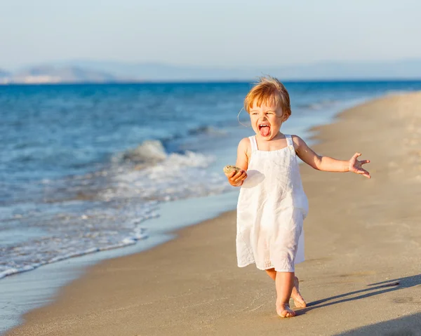 Kleines Mädchen läuft am Strand — Stockfoto