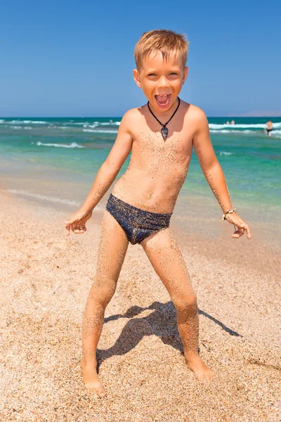 Boy on the beach with sea on background Stock Image
