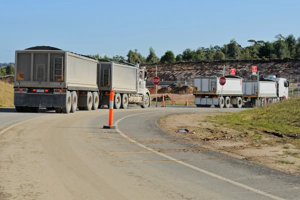 Construction trucks at turn — Stock Photo, Image