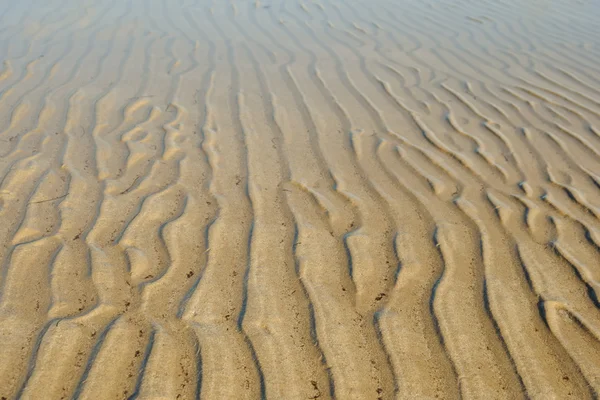 Písek vlny ve vodě — Stock fotografie