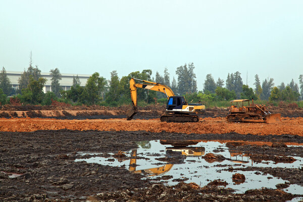 Excavator Loader with backhoe standing in sandpit