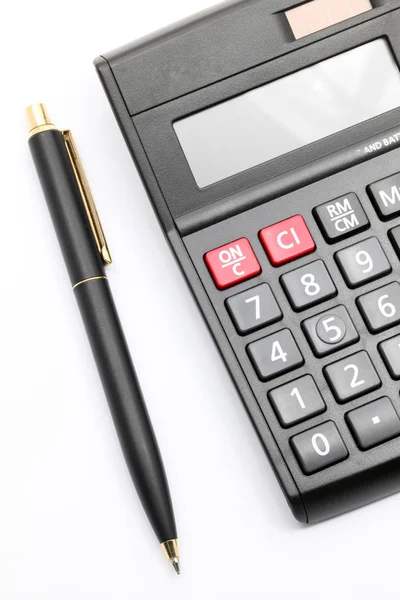 Калькулятор и ручка — стоковое фото