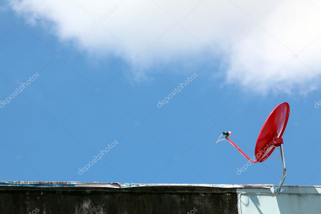 Isolated red satellite on sunny blue sky