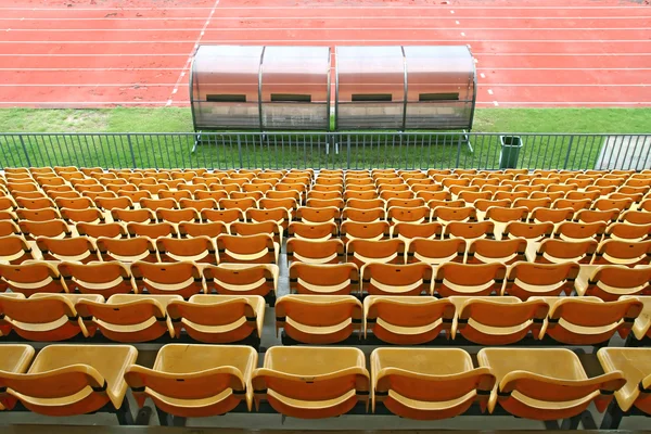 Coach and reserve benches with yellow seats in football stadium Back Perspective — Stock Photo, Image