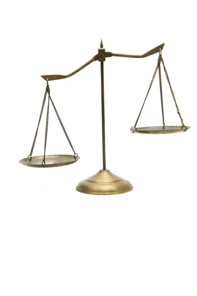 Unbalance of golden brass scales of justice on white — Stock Photo, Image