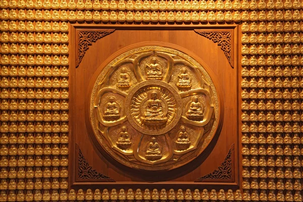 Golden wheel of buddha on wall in dragon temple Thailand — Stock Photo, Image