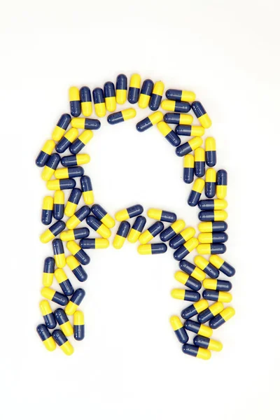 The letter A alphabet made of medical capsules — Stock Photo, Image