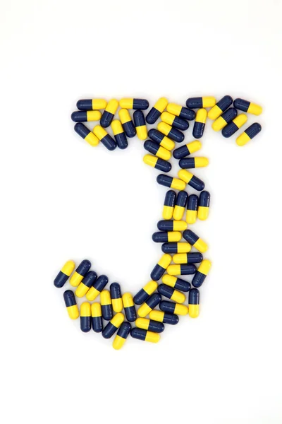 A letra J alfabeto feito de cápsulas médicas — Fotografia de Stock