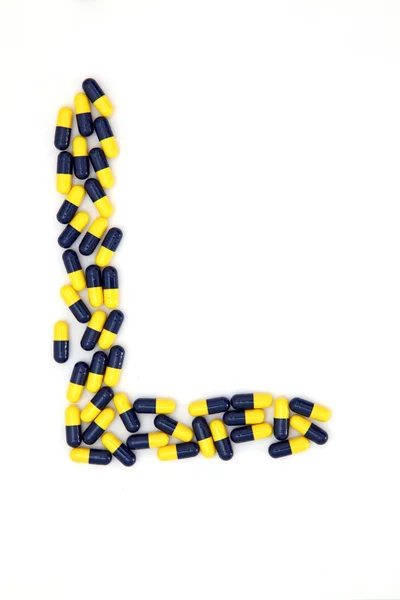 The letter L alphabet made of medical capsules — Stock Photo, Image