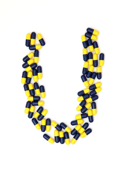 The letter U alphabet made of medical capsules — Stock Photo, Image