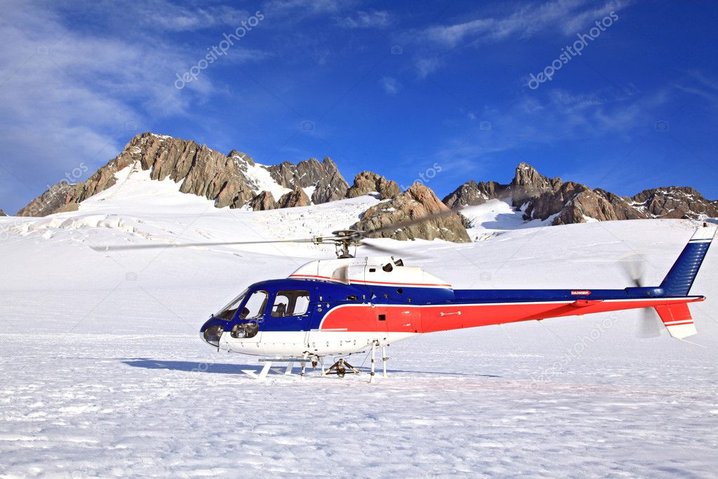 Helicopter landing on top of Franz Josef Glacier in New Zealand.