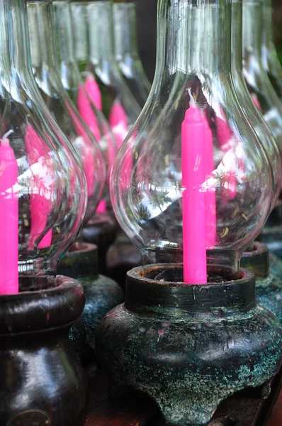 Pink candle in glass bowl containing — Stock Photo, Image