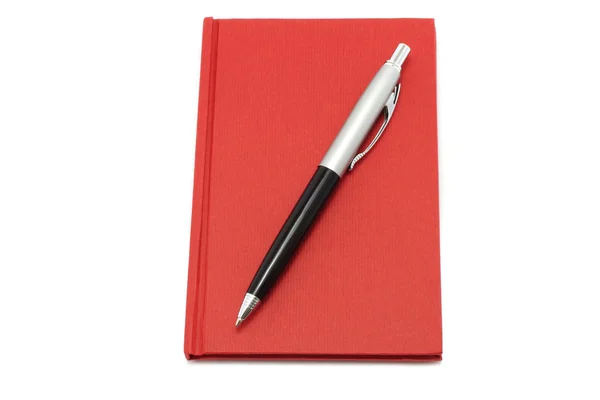 Bloco de notas vermelho com caneta esferográfica — Fotografia de Stock