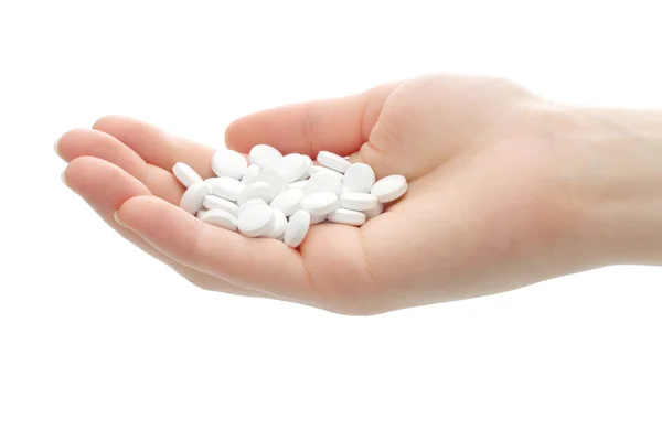 Pílulas redondas brancas na mão — Fotografia de Stock