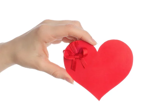 Ruka drží papír srdce s lukem — Stock fotografie